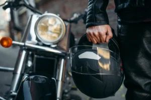man carrying motorcycle helmet