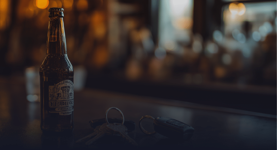 Beer Bottle Kept on a Table with Car keys nearby - Drunk Driving