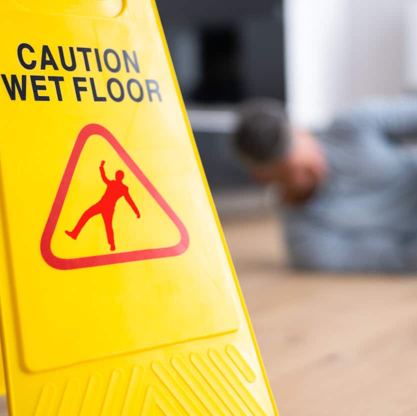 a slip and fall sign with an accident occurring